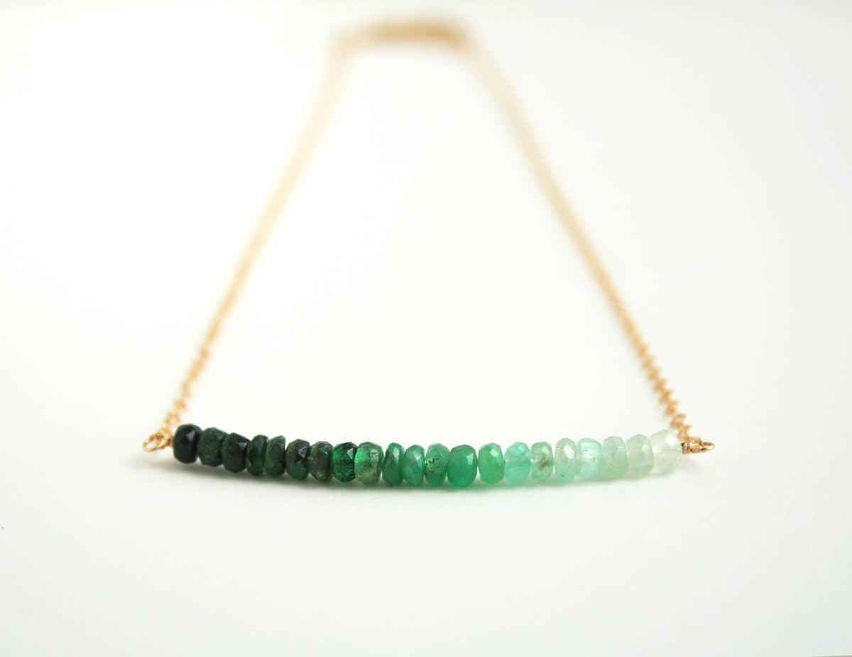 Necklace with green ombre stones on a white background