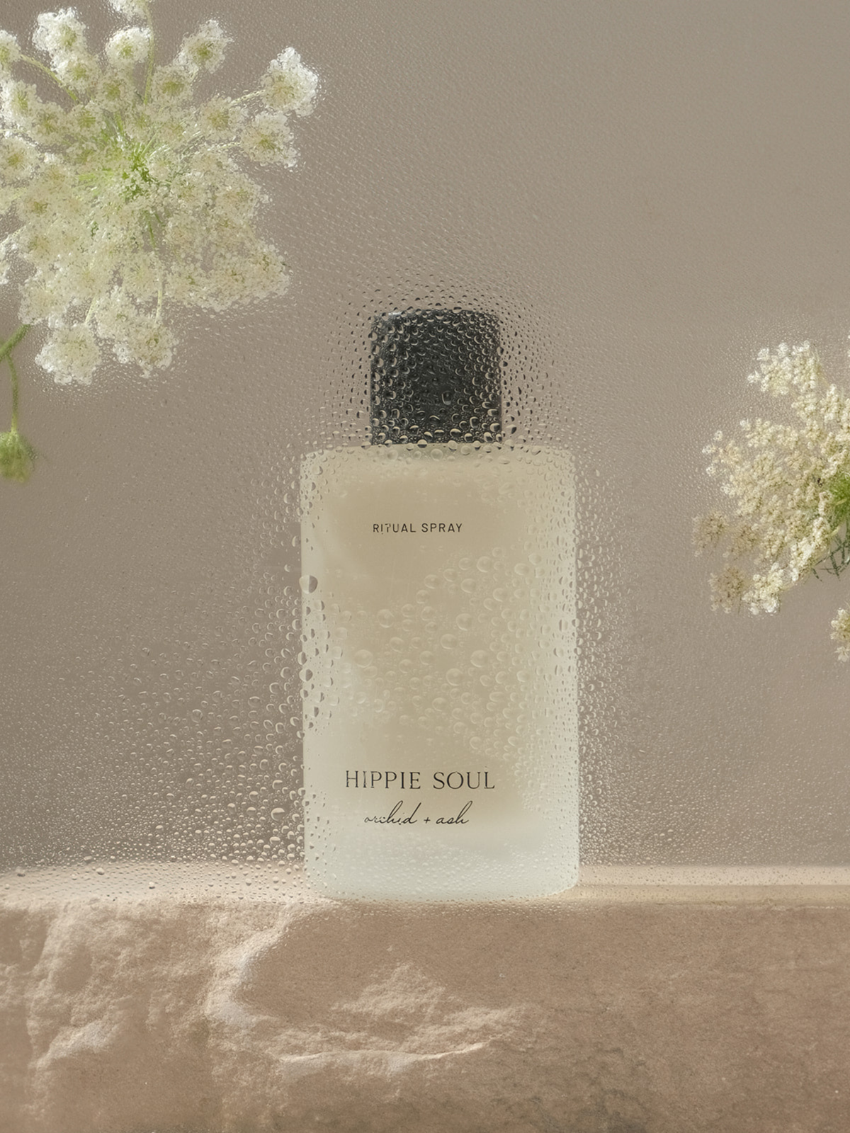 Perfume bottle labeled 'Hippie Soul' with white flowers on a neutral background