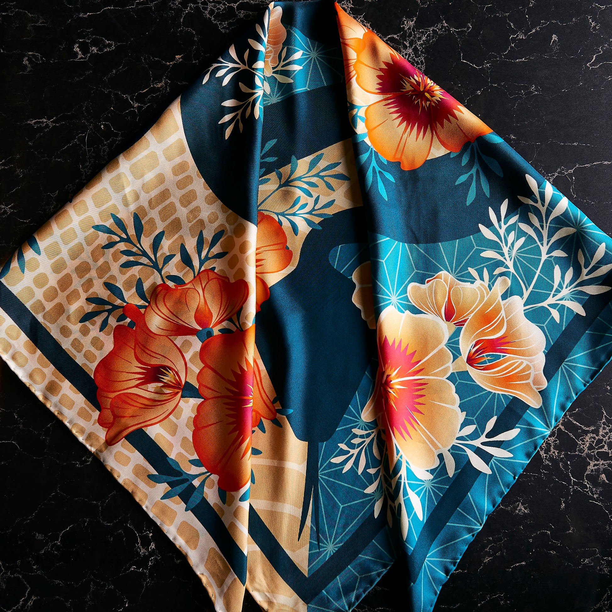 Floral patterned silk scarf on a dark marble surface