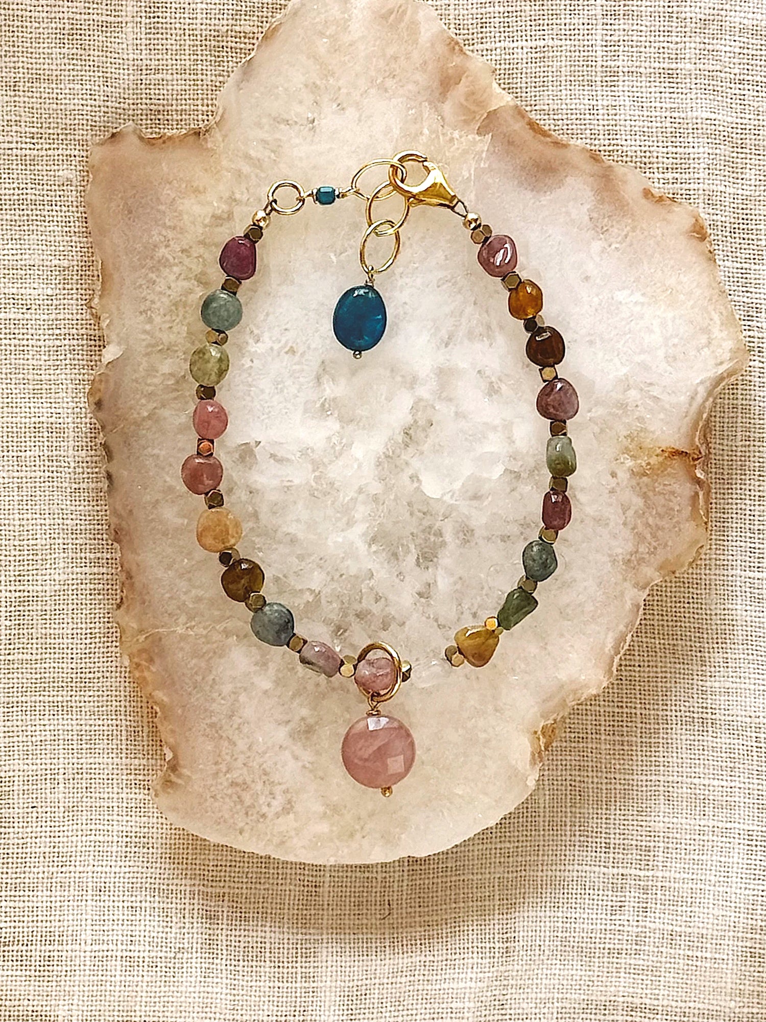 Necklace with multicolored beads on a textured stone surface